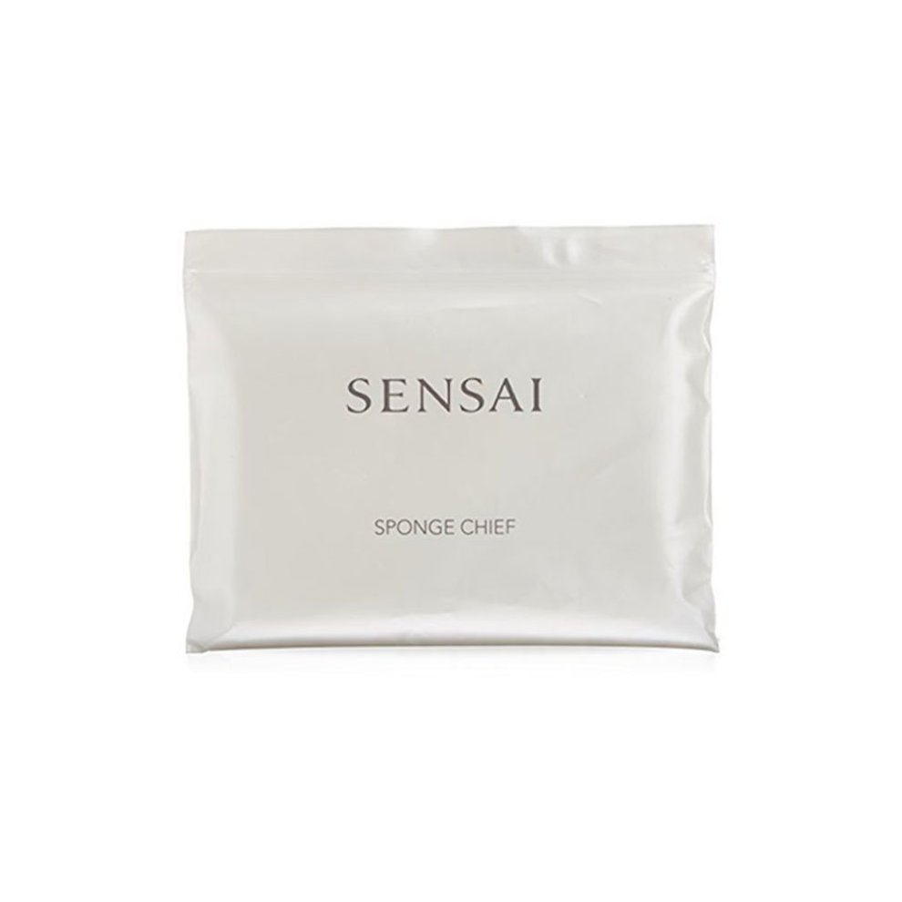 White packaging with a sleek design featuring the word "SENSAI" and "SPONGE CHIEF," containing a single Kanebo Sensai Silky Purifying Sponge, emphasizing purity and luxury.