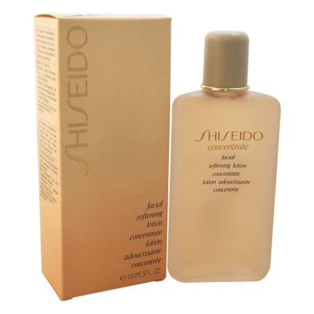 Shiseido Concentrated Softening Face Lotion in a clear, amber bottle with a gold cap, accompanied by a matching beige box featuring elegant text and product details.