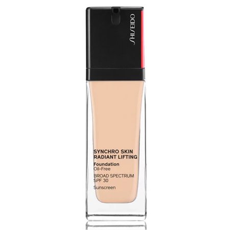 Shiseido Synchro Skin Radiant Lifting Foundation in Nude, featuring a sleek glass bottle with a black pump top and red accent, labeled with product details and SPF 30.
