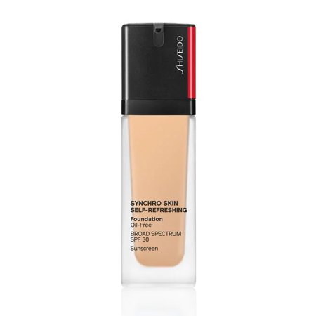 Shiseido Synchro Skin Self Refreshing Foundation in a clear glass bottle, featuring a black pump top and red accent, with a light beige liquid visible inside.