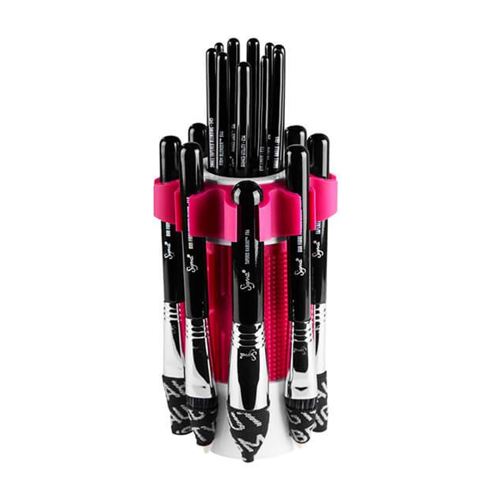 Debenhams Dry 'n Shape Spa in Pink features a cylindrical holder with a vibrant pink band, containing various black and silver makeup brushes arranged upright.