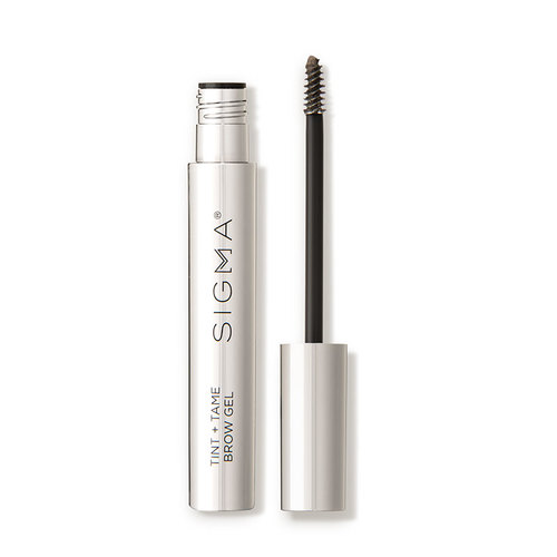 Transparent eyebrow gel in a sleek silver tube with a black applicator brush, labeled "SIGMA TINT + TAME," designed for taming and tinting brows.