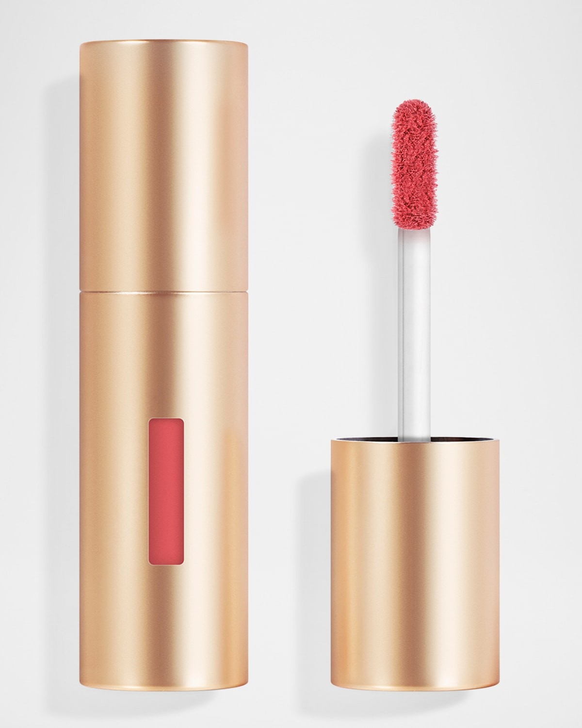 Gold cylindrical lipstick tube with a clear window, featuring a soft, fuzzy applicator tip and a creamy pinkish-red lip product inside.