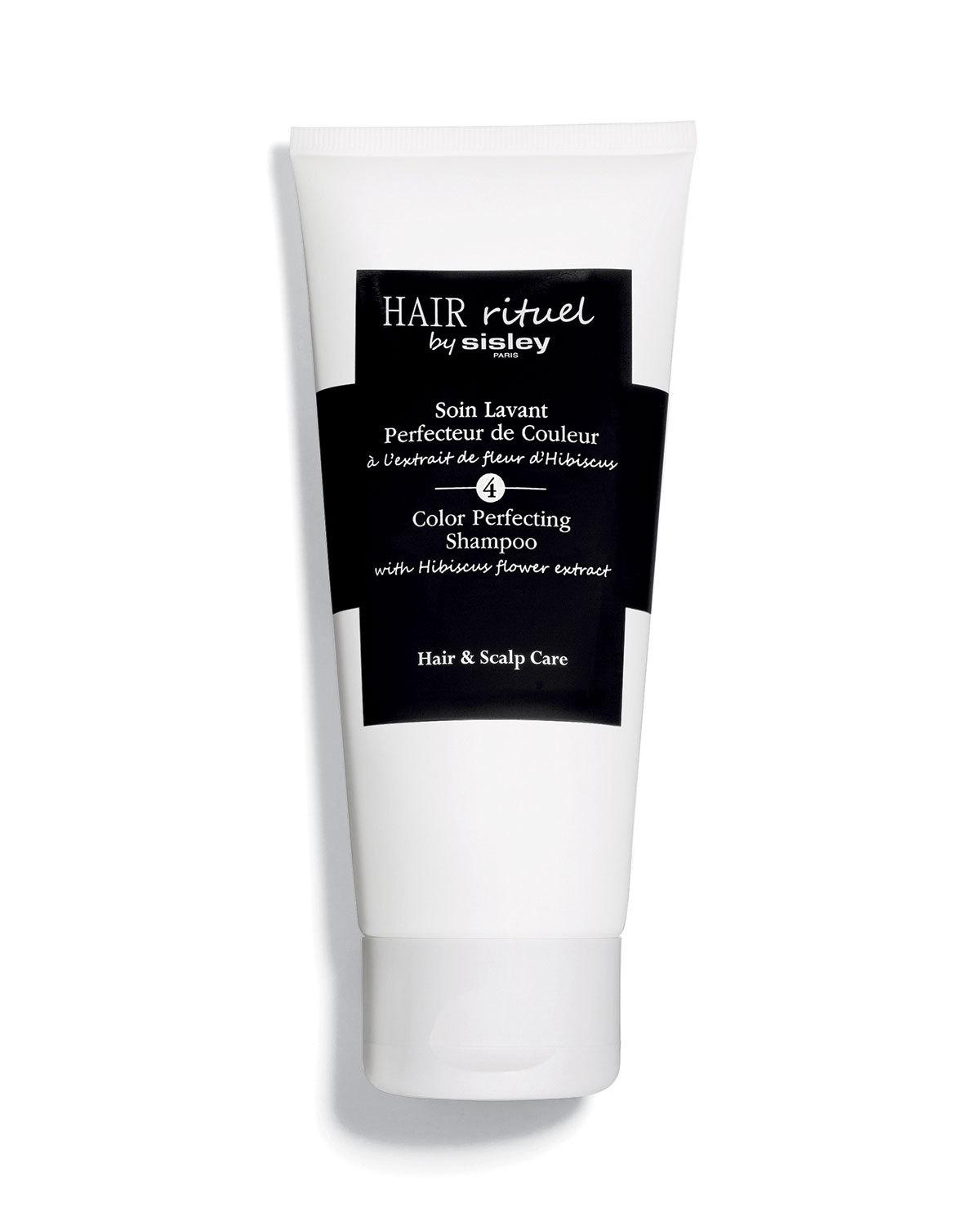 White tube of Sisley-Paris Hair Rituel Color Perfecting Shampoo, featuring a black label with text, and highlighting hibiscus flower extract, 6.7 oz size.