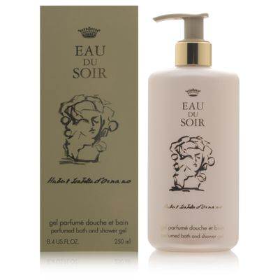 A creamy white bottle with a pump top, labeled "Eau Du Soir," alongside an elegant green box featuring a classic illustration and gold accents, both from Sisley-Paris.
