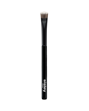 Black eyeshadow shade brush with a flat, tapered bristle head, featuring soft synthetic fibers for precise application, and a sleek handle with the Sisley logo.
