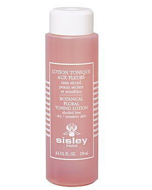 A pink, cylindrical bottle of Sisley Paris Floral Toning Lotion, featuring white text and a clean design, labeled as alcohol-free for dry and sensitive skin.