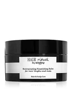 Black jar with a sleek design, featuring a white label that reads "HAIR rituel by Sisley Restructuring Nourishing Balm" for hair lengths and ends, emphasizing hair and scalp care.