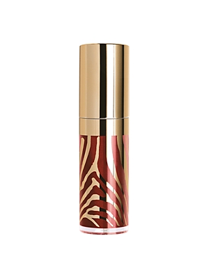Brown lip gloss in a sleek, gold-capped tube featuring a stylish zebra print design in shades of brown and gold.