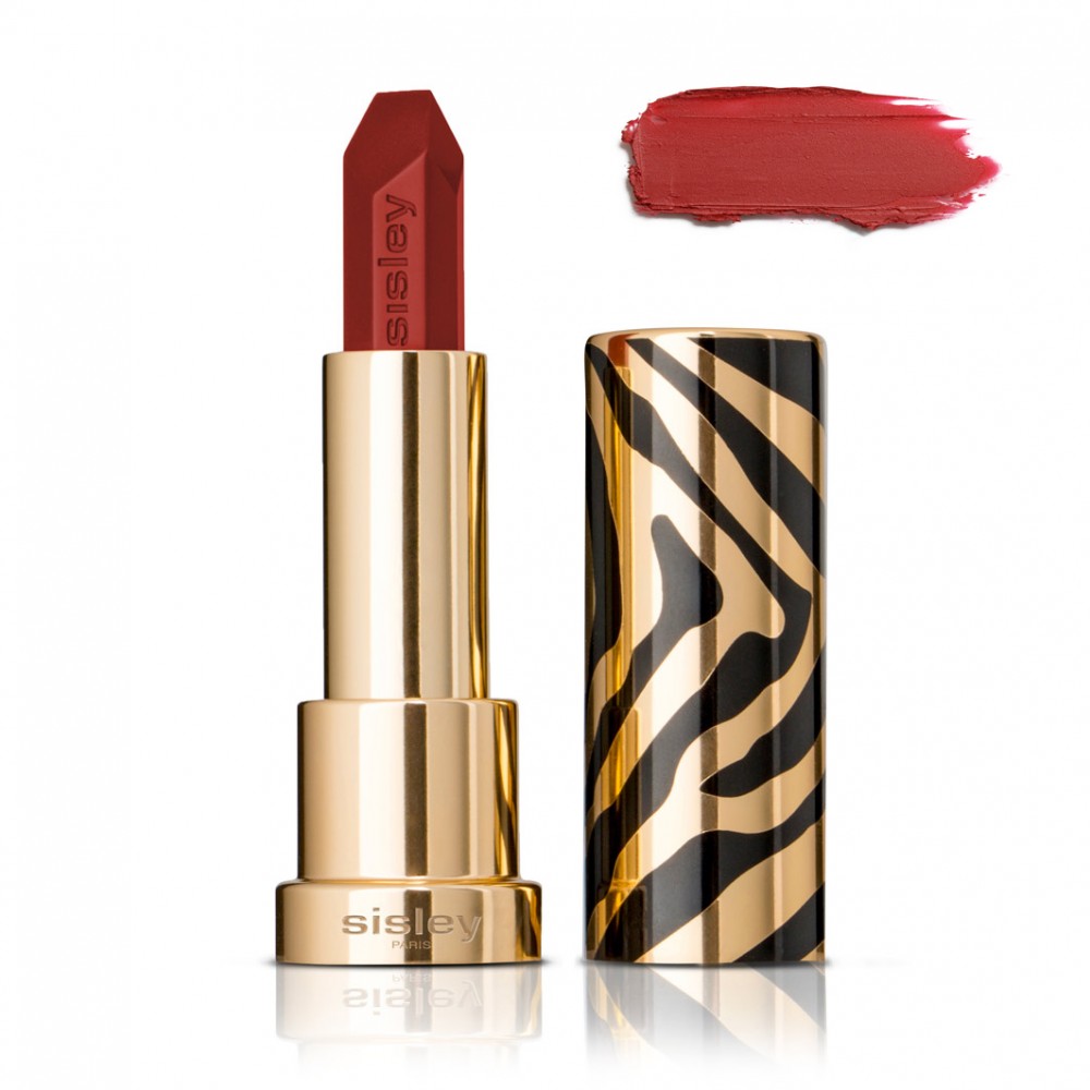 Bold red lipstick in a sleek gold and black zebra-striped case, accompanied by a swatch of the same rich red shade.