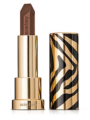 Sisley Le Phyto Rouge in a rich brown shade, housed in a sleek gold tube with a striking black and gold zebra print design.