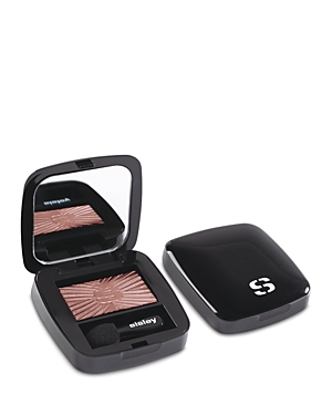 Black compact with a mirrored lid, featuring a rosy-brown eyeshadow with a sunburst pattern and a small applicator inside. The Sisley logo is embossed on the compact.