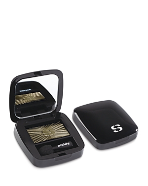 Black compact with a mirror, featuring a gold and green luminous eyeshadow inside, embossed with a sunburst design and the Sisley logo on the lid.