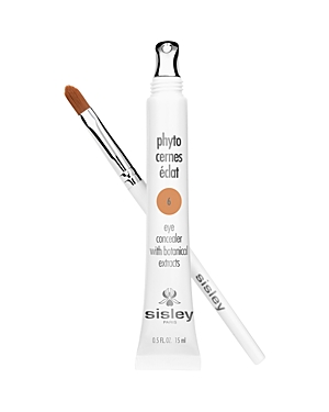 White tube with silver accents labeled "Phyto Cernes Éclat 6 Deep," accompanied by a small brush applicator, designed for under-eye concealing with botanical extracts.