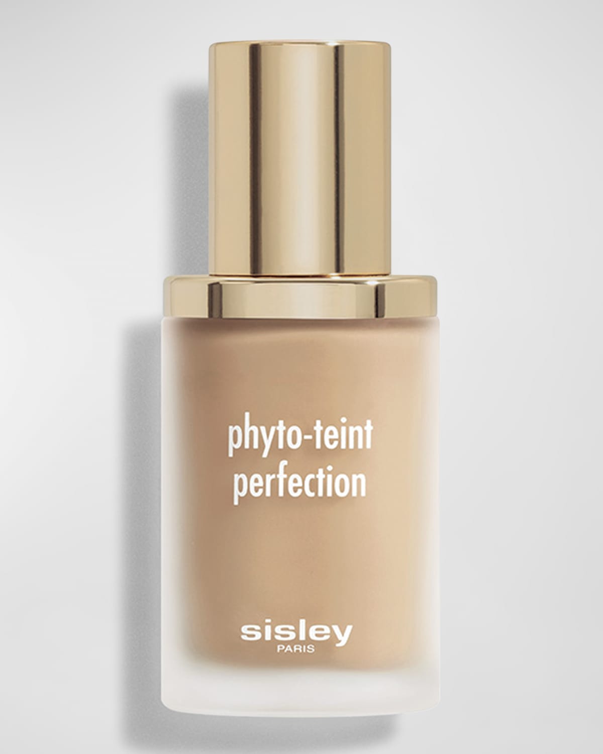 Beige liquid foundation in a clear glass bottle with a gold cap, featuring white text that reads "phyto-teint perfection" and "sisley" at the bottom.