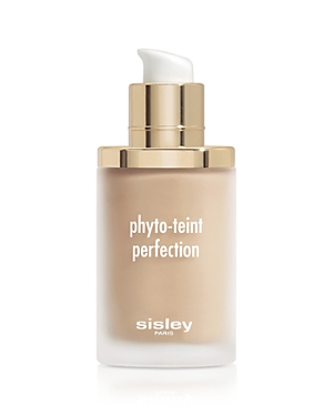 Transparent glass bottle with a gold pump top, containing light beige foundation labeled "phyto-teint perfection" by Sisley-Paris.