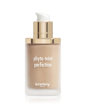 Glass foundation bottle with a gold pump cap, featuring a frosted finish and white text that reads "phyto-teint perfection" and "sisley paris," in a warm beige shade.