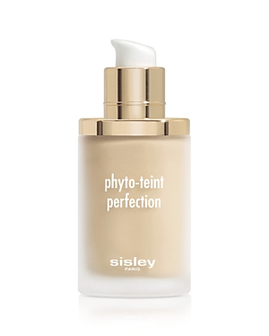 Glass foundation bottle with a frosted finish, featuring a gold pump and cap, labeled "phyto-teint perfection" in white text, showcasing a light beige liquid inside.