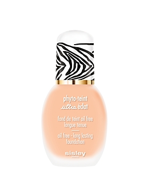 Sisley-Paris Phyto-Teint Ultra Eclat Foundation features a sleek bottle with a zebra-striped cap, showcasing a light peach liquid foundation labeled as oil-free and long-lasting.