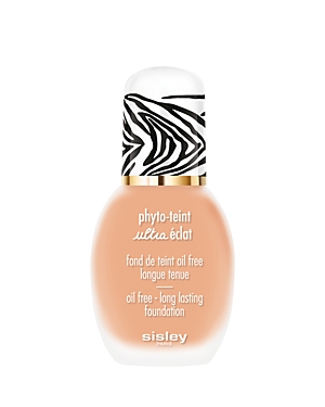 Sisley-Paris Phyto-Teint Ultra Éclat Foundation in a sleek glass bottle with a zebra-print cap, featuring a soft peach shade and gold accents.