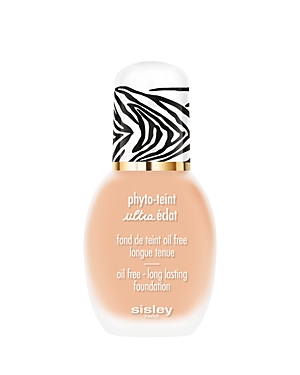 Light beige foundation bottle with a zebra-striped cap and gold accents, labeled "Phyto-Teint Ultra Éclat" by Sisley, emphasizing its oil-free and long-lasting formula.