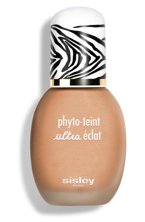 A beige foundation bottle with a rounded shape, featuring a black and white zebra-striped cap and the text "phyto-teint ultra éclat" in white on the front.