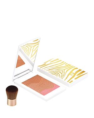 Sisley Phyto Touche Sun Glow Powder in a white compact with gold zebra stripes, featuring a bronzer and blush, accompanied by a small, soft brush.