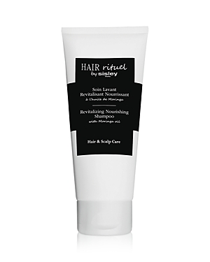 White tube with a black label, featuring the text "Hair Rituel by Sisley" and "Revitalizing Nourishing Shampoo" prominently displayed, 6.7 oz size for hair and scalp care.
