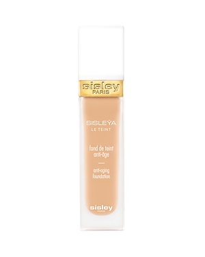 Sisley Paris Sisleya Le Teint Anti-Aging Foundation in a sleek glass bottle with a gold cap, featuring a light beige shade and elegant branding on the front.