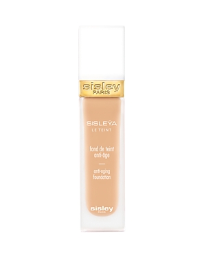 Sisley Paris Sisleya Le Teint Anti-Aging Foundation in a sleek, transparent bottle with a gold cap, featuring a light beige shade for a natural finish.