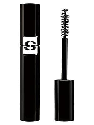 Black tube of Sisley So Volume Fortifying Mascara with a shiny finish, featuring a white logo, alongside a black bristle wand for application.