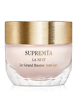 Luxurious glass jar with a gold lid, containing Sisley-Paris Supremya at Night anti-aging cream, featuring elegant branding in gold lettering on a soft pink base.