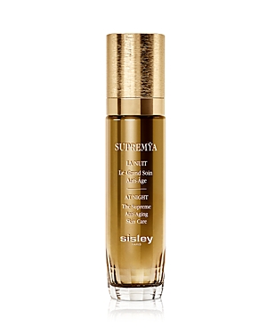 Gold and clear glass bottle of Sisley-Paris Supremya at Night anti-aging skin care, featuring a gold cap and elegant label, containing 1.6 oz of product.