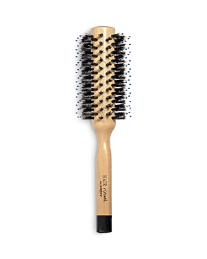 Round blow-dry brush with a wooden handle, featuring black bristles and a ceramic barrel, designed for styling hair effectively.