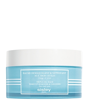 Light blue jar with a white lid, labeled "Sisley-Paris Triple-Oil Balm Make-up Remover & Cleanser," featuring a clean, modern design for face and eyes.