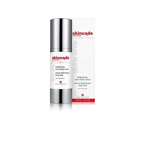 Skincode Essentials Alpine White Brightening Total Clarity Serum in a sleek silver and white pump bottle, featuring a red logo and text, with a 30ml capacity.