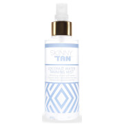 Clear spray bottle with a gold cap, featuring a white and light blue geometric design, labeled "Skinny Tan Coconut Water Tanning Mist - 150ml - Suitable for Face & Body."