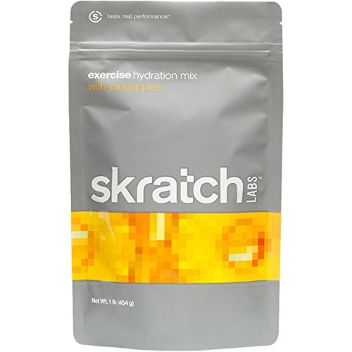 Skratch Labs hydration mix in a gray pouch with vibrant yellow-orange pineapple graphics, labeled "exercise hydration mix," 454g net weight.