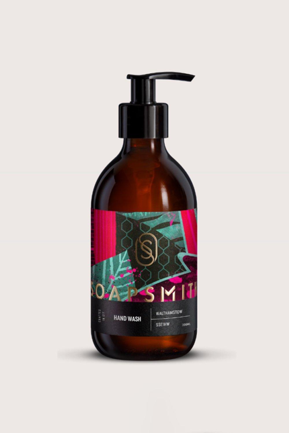 Amber glass bottle of Walthamstow Hand Wash by Soapsmith, featuring a colorful label with geometric patterns and a black pump dispenser.