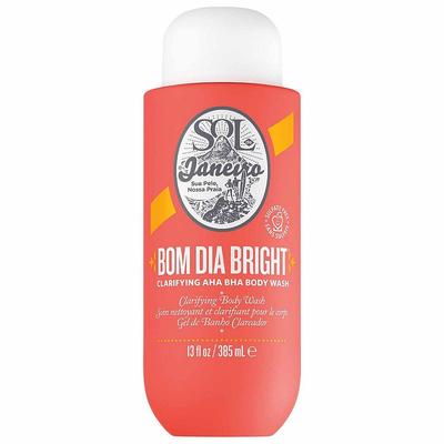 Bright coral bottle with a white cap, featuring the Sol de Janeiro logo and "Bom Dia Bright" label, indicating a clarifying AHA BHA body wash, 13 fl oz.