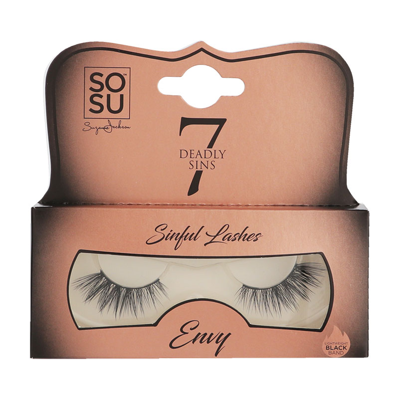 False eyelashes in a clear tray with a black band, featuring long, wispy strands labeled "Envy" from the SOSU Cosmetics 7 Deadly Sins collection, in a stylish peach and gold packaging.