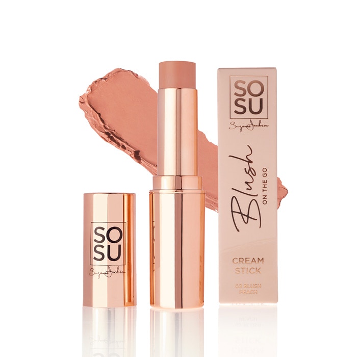 Debenhams blush cream stick in peach, featuring a sleek rose gold tube, with a creamy texture and a matching swatch beside it, packaged in a stylish box.