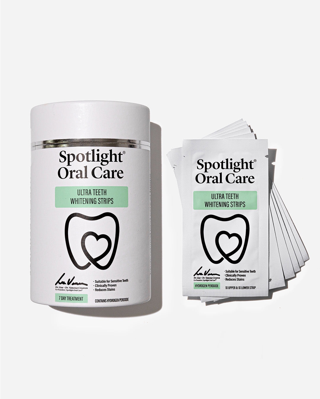 Spotlight Oral Care 7 Day Ultra Teeth Whitening Strips in a white cylindrical container with a heart logo, alongside individual foil packets of whitening strips.