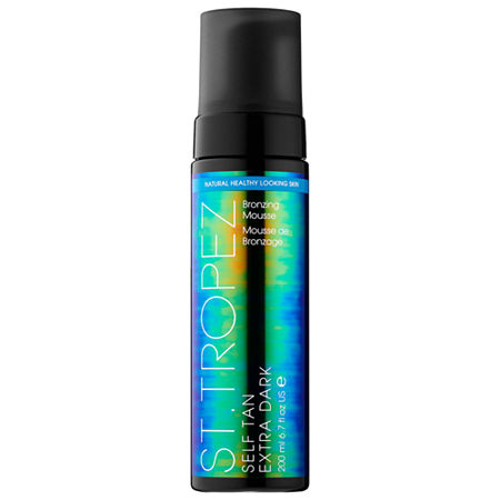 St.Tropez Self Tan Extra Dark Bronzing Mousse in a sleek black bottle with a vibrant blue and green label, featuring a pump dispenser, 200ml/6.7oz size.