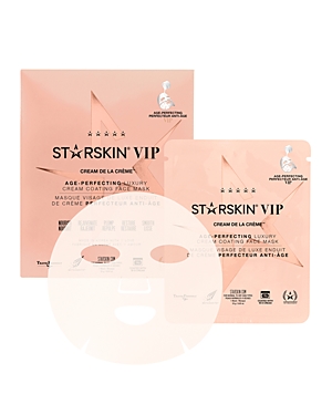 STARSKIN Cream De La Creme Age Perfecting Mask features a sleek, rose gold packaging with a luxurious design, showcasing a facial mask inside for anti-aging benefits.