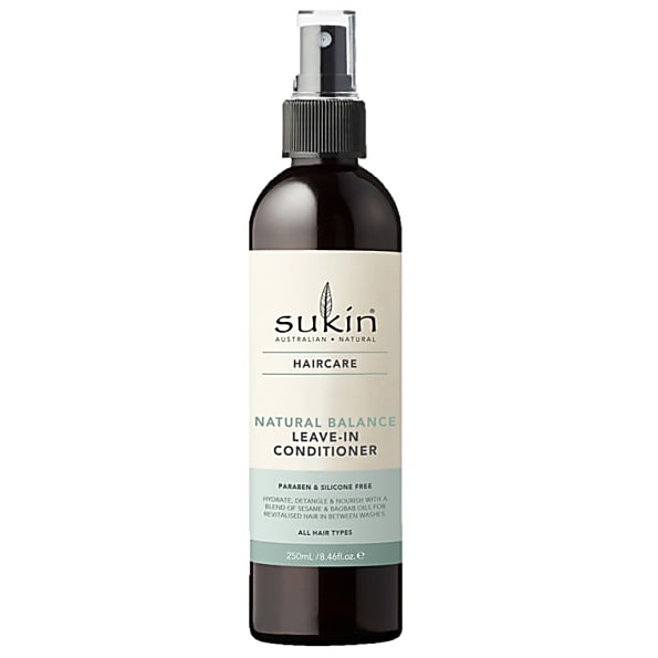 Sukin Natural Balance Leave-in Conditioner in a dark amber spray bottle with a black pump, featuring a cream label with green accents, suitable for all hair types.