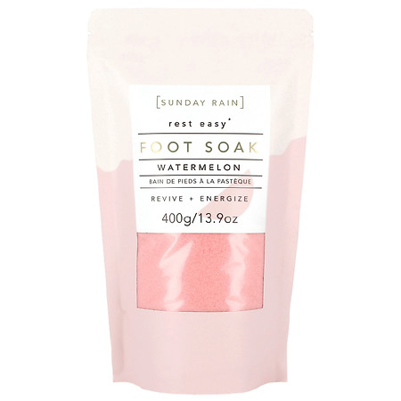 Pink and white pouch of Sunday Rain Foot Soak labeled "Watermelon," featuring a 400g weight and text highlighting "Revive + Energize."