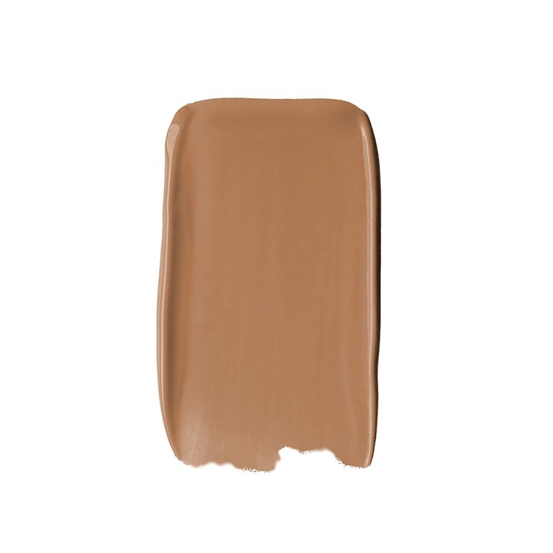 A smooth, creamy swatch of Sweed Glass Skin Foundation in a warm, medium brown shade, showcasing its rich, velvety texture.