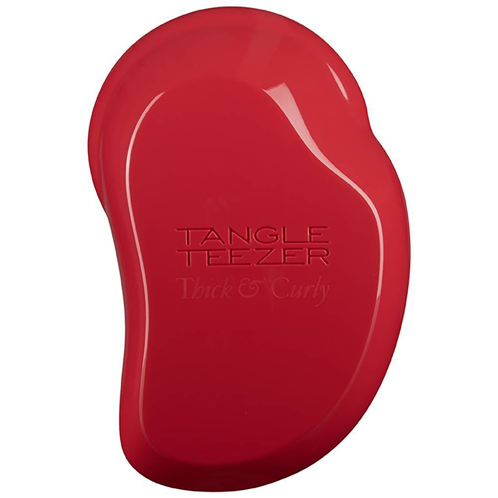 Red Tangle Teezer Thick & Curly hairbrush featuring a unique ergonomic shape and soft bristles designed for detangling thick and curly hair.