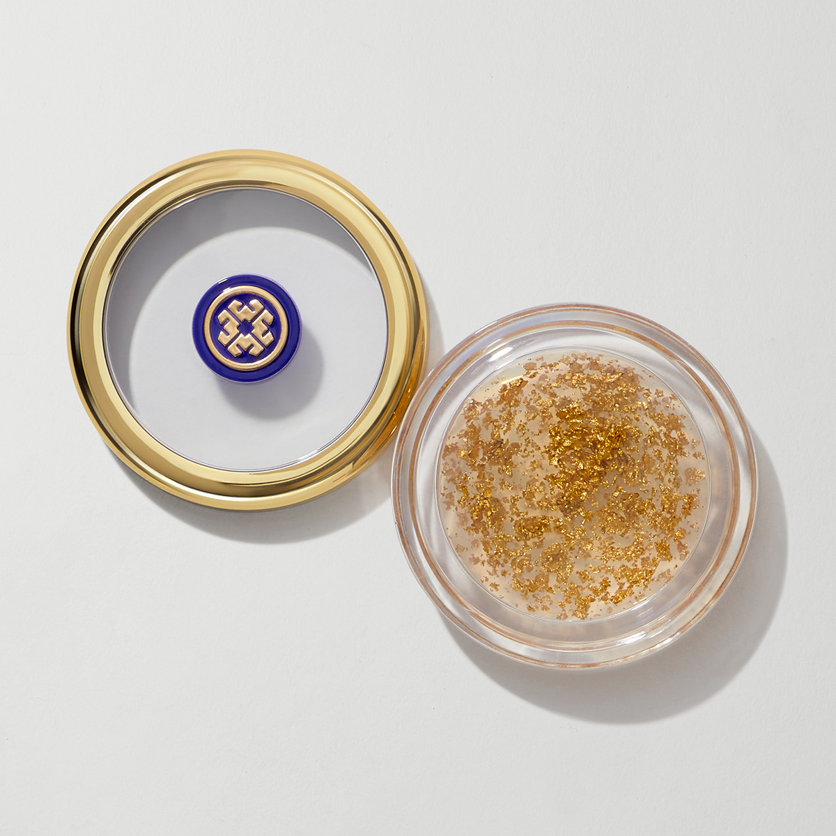 Tatcha Camellia Gold Spun Lip Balm in a clear jar with a gold lid, featuring shimmering gold flakes inside, showcasing luxurious Japanese skincare.